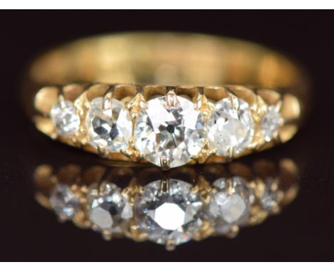 A c1900 18ct gold ring set with five diamonds, the centre diamond approximately 0.35ct, 2.9g, size L