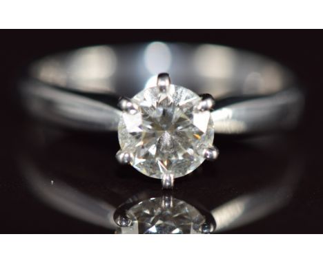 A platinum ring set with a round cut diamond of approximately 0.94ct, 4.4g, size O