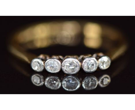 An 18ct gold ring set with five diamonds in a platinum setting, 1.4g, size M