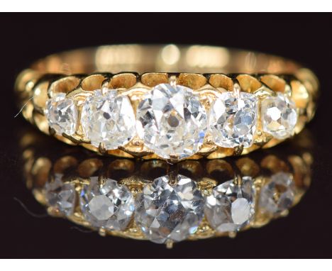 A c1900 18ct gold ring set with five old cut diamonds, the centre diamond approximately 0.35ct,&nbsp;2.8g, size J