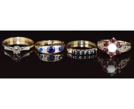 Three 9ct gold rings, one set with an opal and garnets, one sapphires and cubic zirconia and the other sapphires (missing one