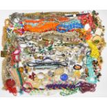 A collection of jewellery including beaded necklaces, vintage brooches, silver rings, silver chains,