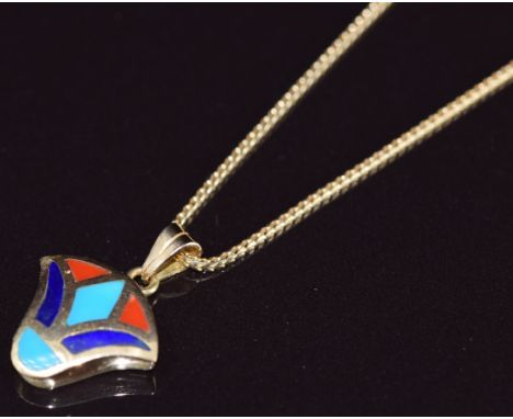 An 18ct gold pendant set with turquoise, lapis lazuli and coral (2.1cm) on 18ct gold chain, 6.5g, 44cm