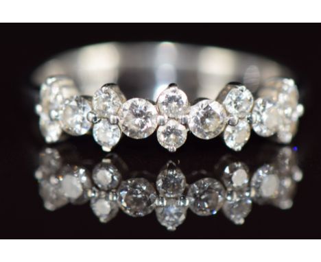 A 9k white gold ring set with fourteen diamonds, totalling approximately 0.49ct, 1.6g, size L