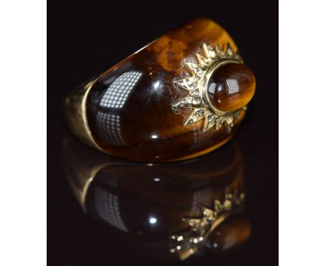 A 9k gold ring set with tiger's eye with a star setting to the centre set with a tiger's eye cabochon, 7.2g, size P