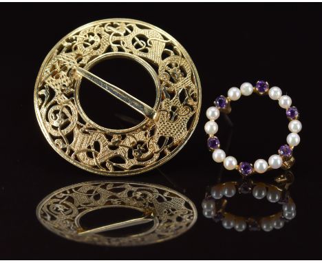 A 14k gold brooch in a pierced Celtic design (8.8g, 3.2cm) and a 9ct gold brooch set with pearls and amethysts (1.6g, 1.8cm)