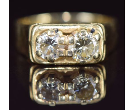 An 18ct gold ring set with two round cut diamonds