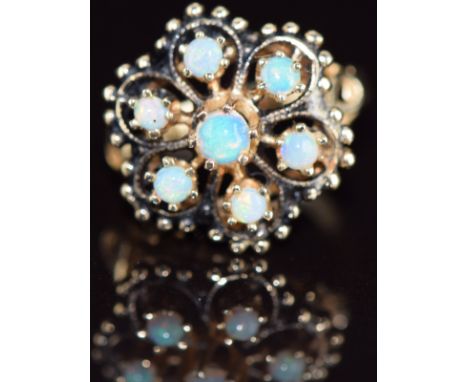 A 14k gold ring set with opals in a flower cluster, 4.1g, size J/K