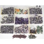 A collection of loose uncut gemstones including tourmaline (total 200ct), blue topaz, emerald,