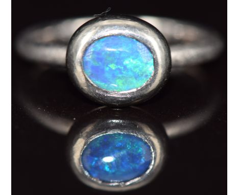 An 18ct white gold ring set with an opal doublet, 6g, size N