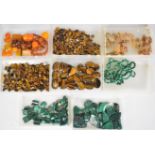 A collection of tiger's eye, malachite and amber including 29 tiger's eye cabochons (3.9 x 2.9cm),