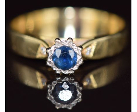 An 18k gold ring set with a round cut sapphire and two diamonds, 3g, size N  