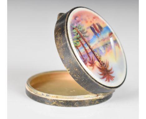 Guilloch&eacute; enamel lidded trinket box or compact, the top decorated with an Arab or similar scene with palm trees, peopl