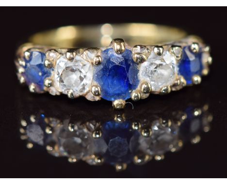 A c1900 18ct gold ring set with three sapphires, two old cut diamonds each approximately 0.35ct and eight rose cut diamonds, 