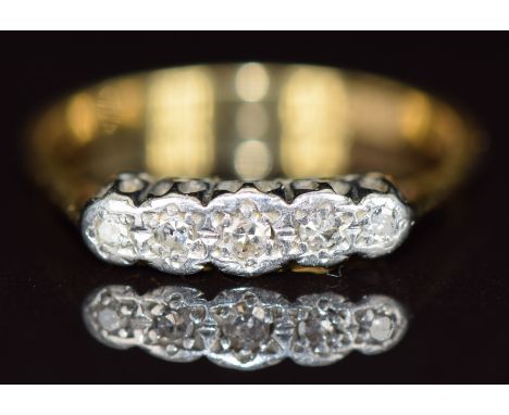 An 18ct gold ring set with five diamonds in a platinum setting, 2.9g, size O