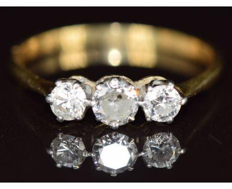 An 18ct gold ring set with three round cut diamonds, the largest approximately 0.3ct, size R/S&nbsp;