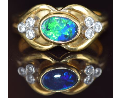 An 18ct gold ring set with a black opal doublet and diamonds, 7.8g, size O