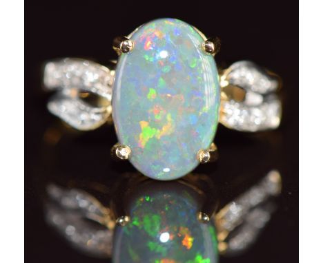 An 18k gold ring set with a Lightning Ridge black opal of approximately 2.2ct and diamonds to the shoulders, 3.4g, size N