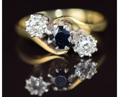 An 18ct&nbsp;gold ring set with a sapphire and two diamonds in a twist setting, 4g, size N