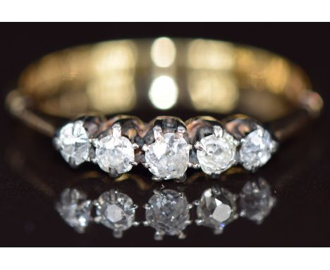 An 18ct gold ring set with five old cut diamonds, 2.3g, size S
