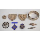 A hallmarked silver nurse's buckle, two silver nursing brooches, Victorian silver brooch with