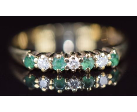 A 9ct gold ring set with diamonds and emeralds, 1.6g, size M