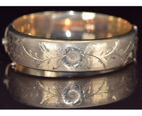 A 9ct gold bangle with engraved floral decoration, 20.2g, 6 x 5.4cm&nbsp;