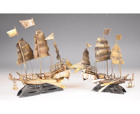 Pair of Chinese or similar silver models of sailing ships or junks, on ebonised bases, height of larger 21cm, weight of both 