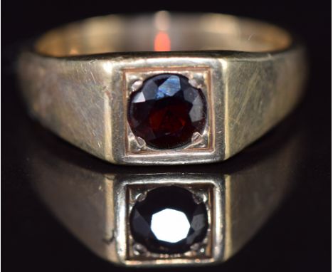 A 9ct gold ring set with a round cut garnet, 8.7g, size Y