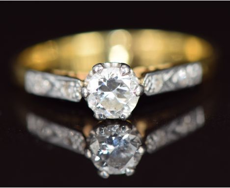 An 18ct gold ring set with a 0.3ct diamond in a platinum setting