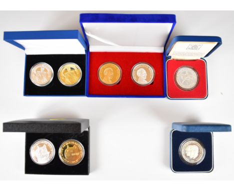 Two Royal Mint cased silver proof commemorative coins, together with three cased pairs of silver and gold plated examples, so