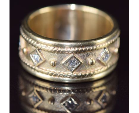 A 9ct gold ring set with five diamonds in diamond shaped settings, 7.8g, size N