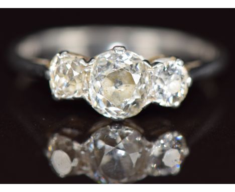 A platinum ring set with three old cut diamonds of approximately 0.8ct, 0.2ct and 0.2ct, 3.1g, size N
