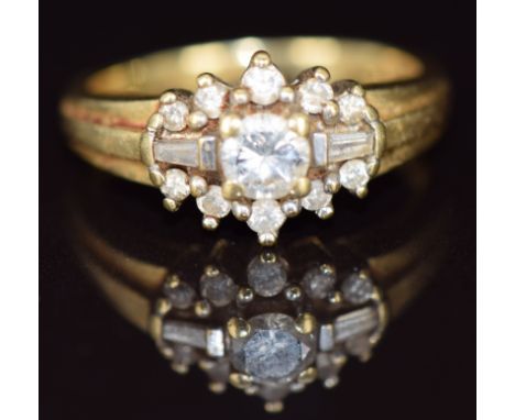 An 18ct gold ring set with round and baguette cut diamonds, 4.9g, size L