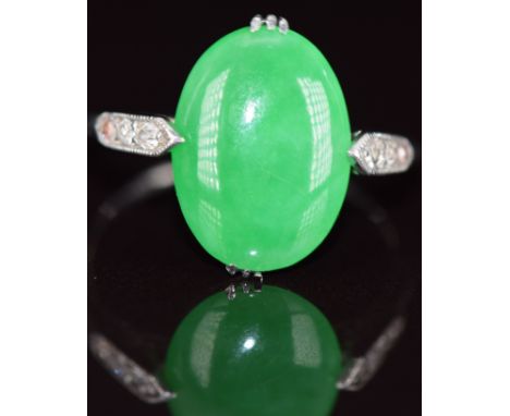 Art Deco platinum ring set with a jade cabochon and three diamonds to each shoulder, 4.2g, size O