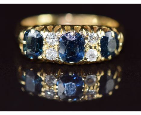 An 18ct gold ring set with sapphires and diamonds, Birmingham 1913, 4.6g, size K