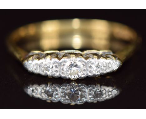 An 18ct gold ring set with five diamonds in a platinum setting, 2.7g, size P