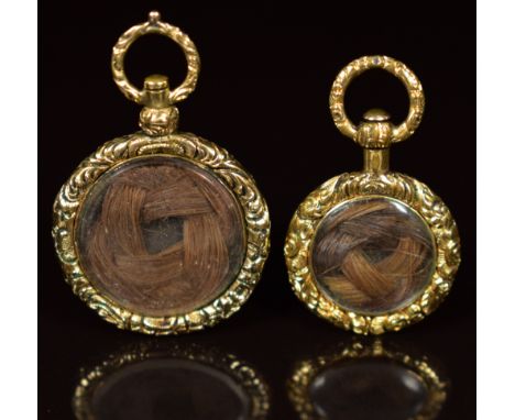 Two yellow metal Victorian mourning lockets with engine turned decoration and a locket compartment verso&nbsp;