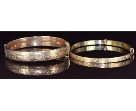 A 9ct gold bangle with engraved decoration (12.5g) and a rolled gold bangle