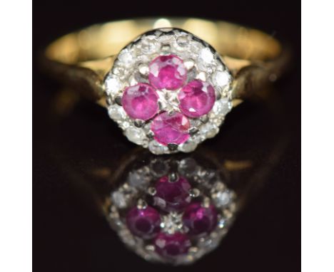 An 18ct gold ring set with four rubies surrounded by diamonds, 3.8g, size N