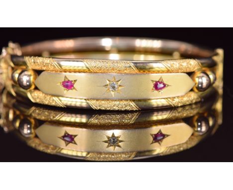 Edwardian 9ct gold bangle set with an old cut diamond and two pear cut rubies, 14.3g, 6.3 x 5cm