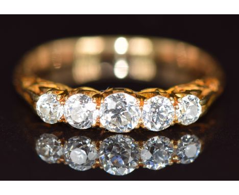 An 18ct gold ring set with five graduated old cut diamonds, the centre diamond approximately 0.24ct, 2.8g, size P