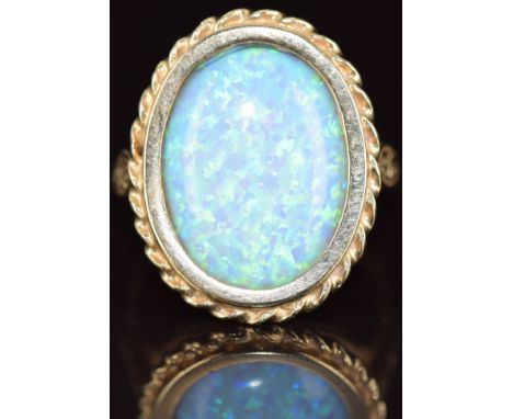 A 9ct gold ring set with a synthetic opal, 5.3g, size S