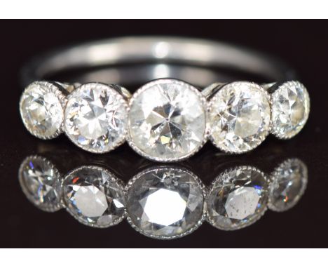 A platinum ring set with five round cut diamonds, the centre diamond approximately 0.6ct, total diamond weight approximately 