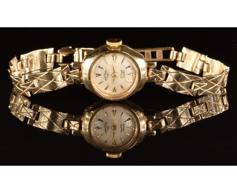 Rotary 9ct ladies wristwatch with gold hands and hour markers, silver dial and 17 jewel movement, on 9ct gold bracelet, case 