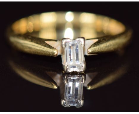 An 18ct gold ring set with an emerald cut diamond of approximately 0.2ct, 2.8g, size L