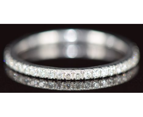 A platinum eternity ring set with diamonds, the total diamond weight approximately 0.25ct, 1.9g, size L