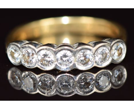 An 18k gold ring set with seven round cut diamonds, each approximately 0.14ct, 4.7g, size P