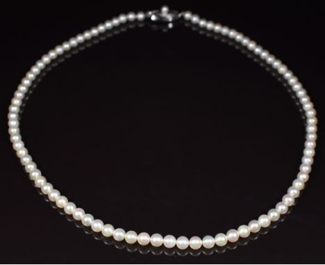 Mikimoto single strand of cultured pearls, the silver clasp set with a further pearl and marked M in a shield, in original Mi