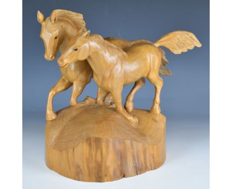 Carved wooden figure of two galloping horses with adzed base in the style of Mouseman, signed and dated possibly M. Lund 1991